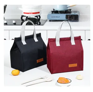 Portable insulated lunch bags in black and burgundy colors shown in a kitchen setting