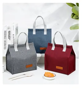 Portable insulated lunch bags in grey, blue, and red colors with fabric texture