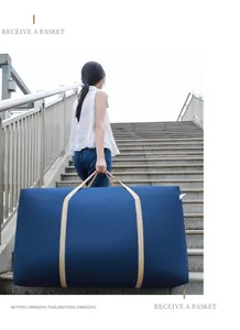 Large navy blue moving storage bag for quilts and bedding shown in use on outdoor stairs.