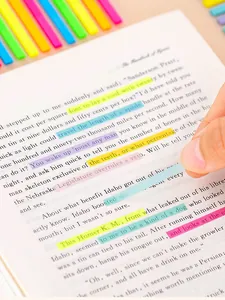 Macro detail of colorful transparent index tabs highlighting English text on book page