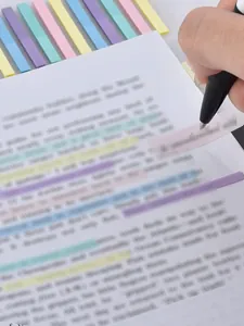 Hand writing on transparent Morandi index sticker over document text detail