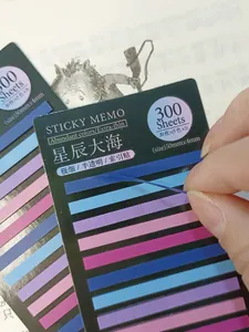 Macro view of a hand peeling an extra-thin blue translucent index sticker tab.