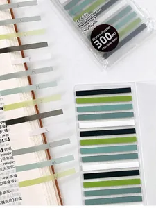 Close-up of colorful transparent index sticky notes used as bookmarks for study.