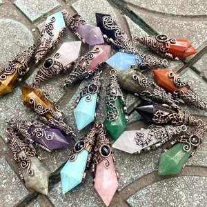 Detailed view of various colorful hexagonal crystal pendants with vintage wire wrap.