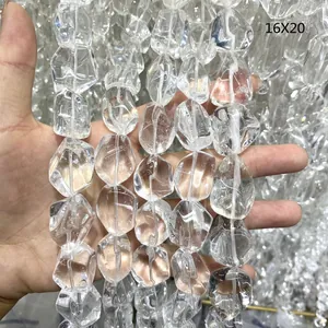 Close-up view of irregular tumbled natural clear quartz crystal beads sized 16x20mm