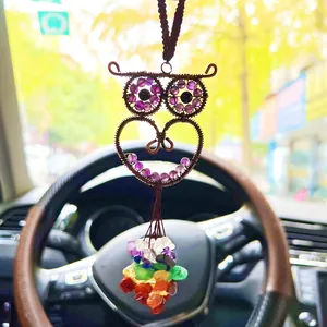 Detailed close-up of a handmade wire-wrapped owl car hanging with colorful rainbow crystal beads
