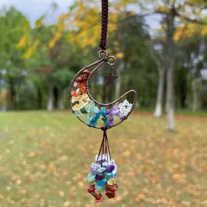 Close-up of handmade moon hanging ornament with rainbow natural crushed crystals and star.