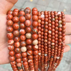 Detailed macro view of natural red dragon blood jasper round loose beads for DIY.