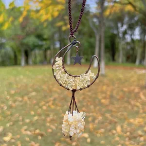 Detailed view of hand-woven moon pendant with yellow citrine crystal crushed stones