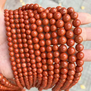 Close-up view of polished natural red jasper round beads for DIY jewelry making accessories
