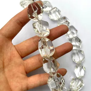 Close-up of natural clear Brazilian quartz beads with irregular tumble-cut facets