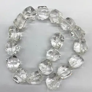 Macro view of natural Brazilian clear quartz beads with irregular faceted cut for DIY