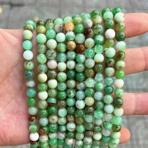 High-quality close-up detail of natural green round stone beads for DIY jewelry making projects