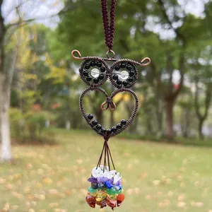 Intricate handmade copper wire owl pendant featuring colorful tumbled chakra crystal stones hanging