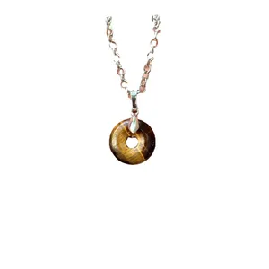 Polished natural tiger eye stone donut pendant hanging on a classic silver link chain