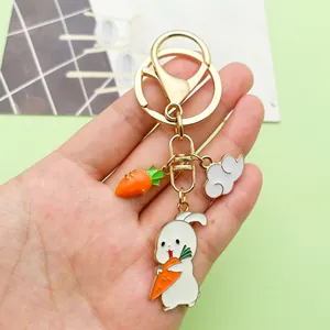 Detailed close-up of a cute enamel bunny and carrot keychain charm with a gold-tone finish