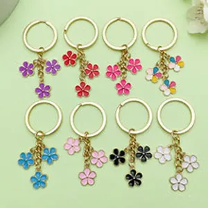 Collection of colorful enamel flower keychains in eight different vibrant shades