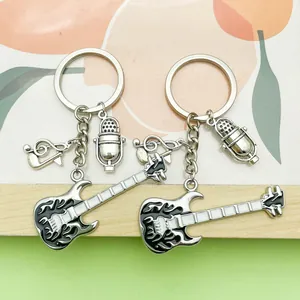 Detail of music theme keychains with guitar, microphone, and music note charms