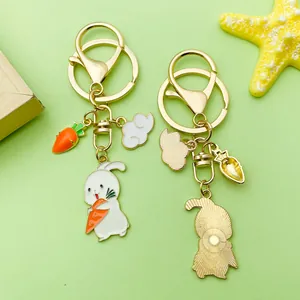 Detailed view of a cute enamel bunny keychain featuring carrot and cloud charms on gold ring