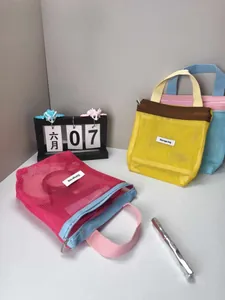 Dopamine-style color-contrast mesh cosmetic bags in a lifestyle desktop setting