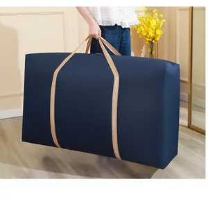 Large capacity dark blue storage bag for clothes and quilts shown in a home setting