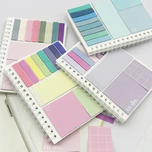Detailed macro shot of multi-colored pastel sticky note pads in a spiral notebook