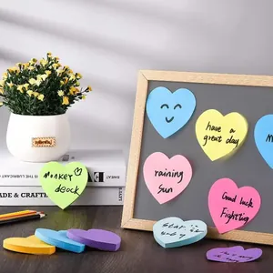 Heart-shaped neon sticky notes in various colors displayed in a creative lifestyle setting
