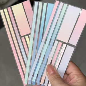 Hand holding colorful gradient transparent index stickers for book reading and notes.