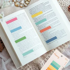 Close-up of semi-transparent colored index stickers highlighting text on book pages