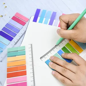 Close-up of colorful transparent index tabs used for marking pages in a notebook.