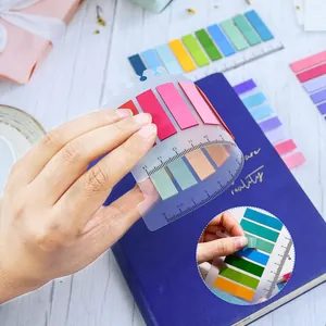 Colorful transparent index tabs on a flexible ruler shown being peeled for marking