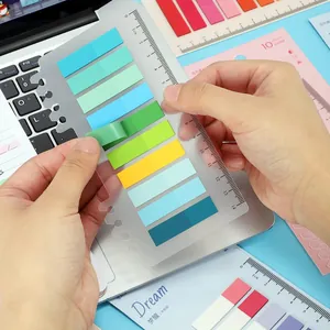 Close-up detail of colorful transparent index sticky notes organized on a functional ruler plate