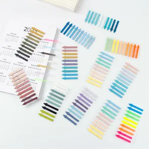 Multiple packs of colorful Morandi arrow index stickers displayed on a white calendar.