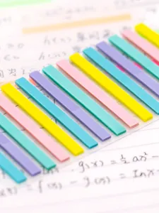 Close-up of colorful translucent PET index tabs used for highlighting notes in a book.