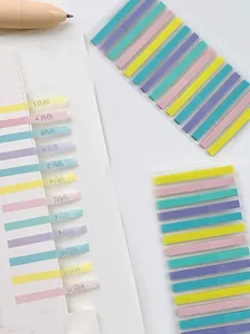 Detail of translucent colorful index tabs used as monthly markers in a notebook.