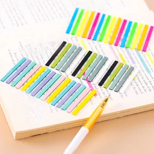 Close-up of colorful transparent index sticky notes on an open book page