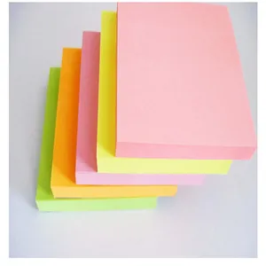 Detail view of five multi-colored fluorescent sticky notes stacked for office use