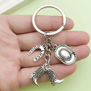 Detail view of cowboy themed keychain with horseshoe, hat and boots charms