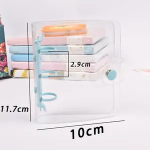 Close-up detail of mini clear PVC 3-ring binder showing dimensions 11.7cm x 10cm x 2.9cm
