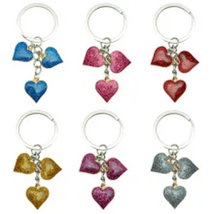 Detailed macro view of colorful glitter heart keychains available in six different shades.