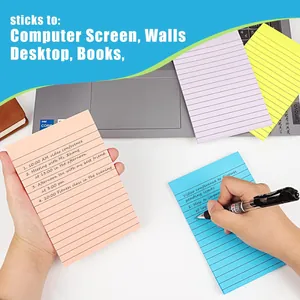 Detailed view of hand writing schedules on a blue lined sticky note with a pen