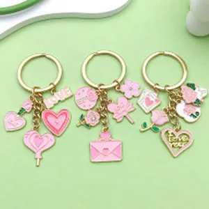 Detail view of pink enamel Valentine's Day keychains with heart and rose charms