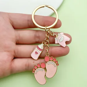 Close-up of cute baby themed alloy enamel keychain with milk bottle and footprint charms