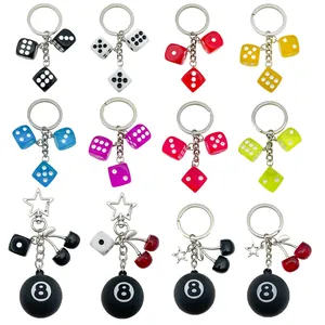 Detailed collection of colorful dice and 8-ball cherry resin keychains for bags.