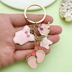 Detail of cute pink alloy keychain featuring baby clothes and elephant charms for bags