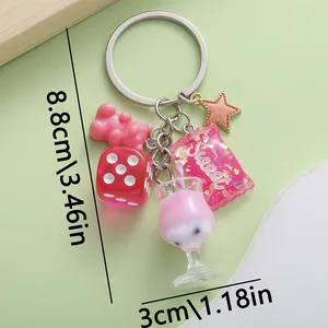 Detailed view of a cute pink resin keychain with dice and bear charms