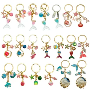 Colección de llaveros de esmalte de temática oceánica con sirena, estrella y conchas