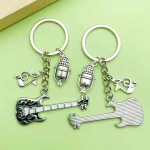 Detailed view of silver-toned keychains with guitar, microphone, and music note charms