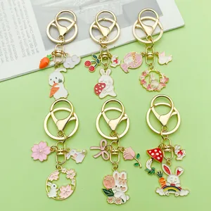Detailed view of various cute enamel rabbit keychains with carrot and flower charms