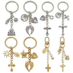 Macro detail of various vintage alloy keychains with cross and angel wing charms